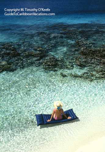 Woman on Raft Floating Over Coral, Bonaire copyright M. Timothy O'Keefe  www.GuideToCaribbeanVacations.com